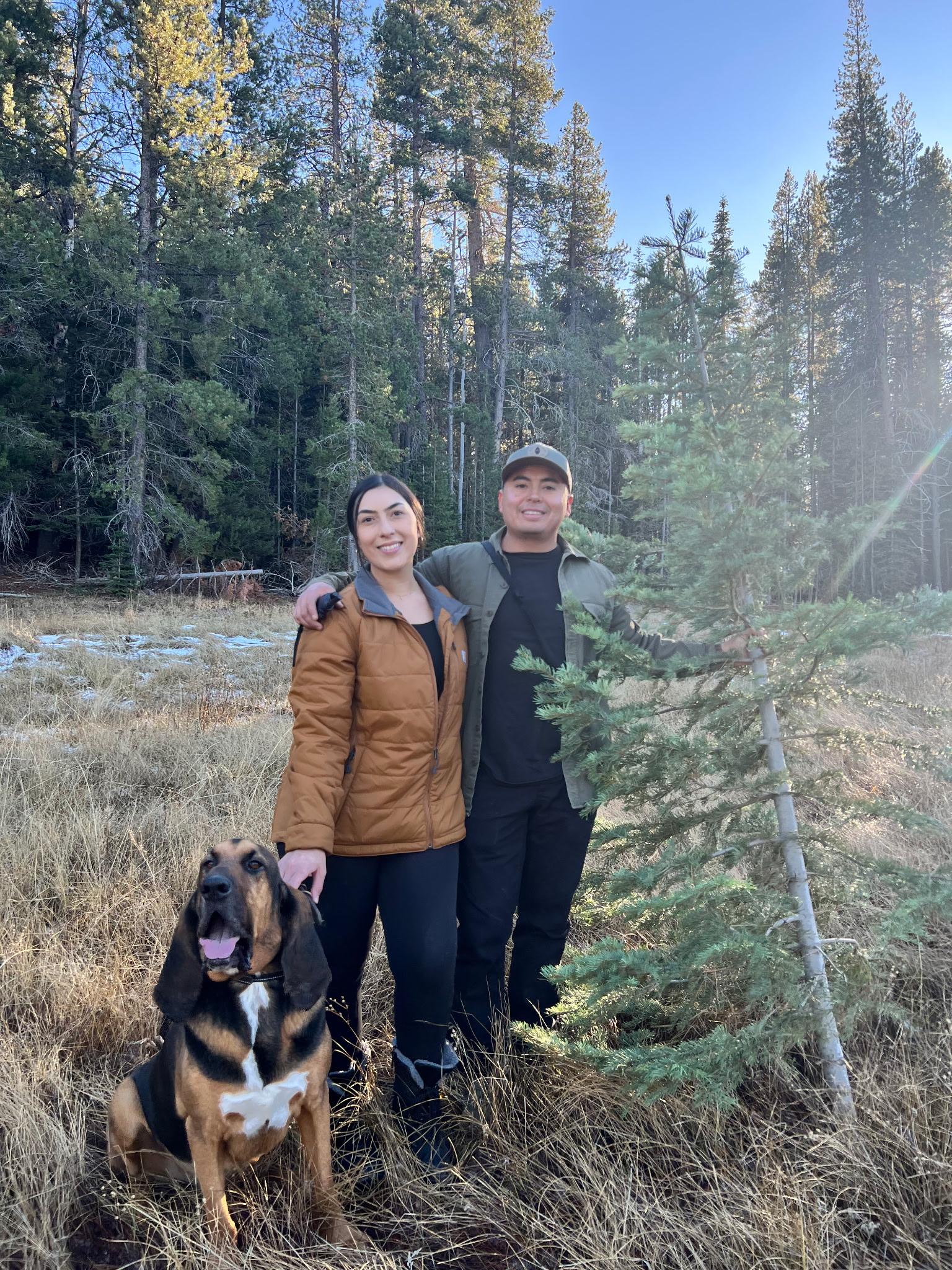 Vivian outdoors with her husband and hound dog